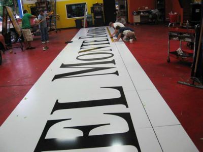 Men working on a store sign