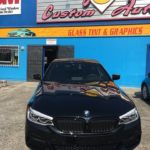 A black BMW in front of Jake’s Custom Auto