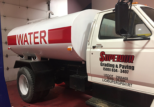 A white water truck with red decal
